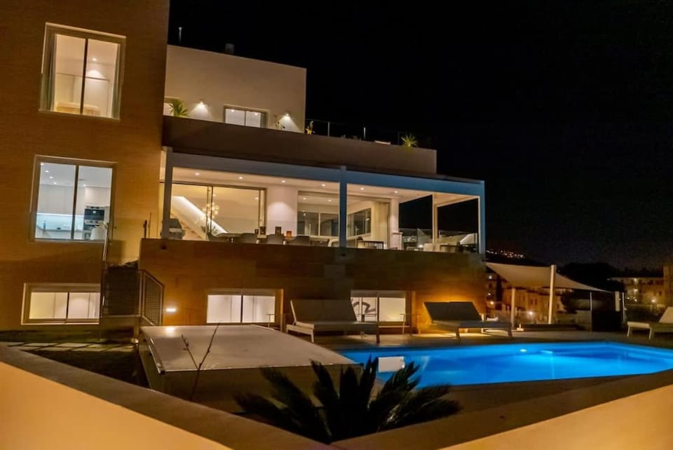 Property building, Patio, Night, Swimming pool, sunbed