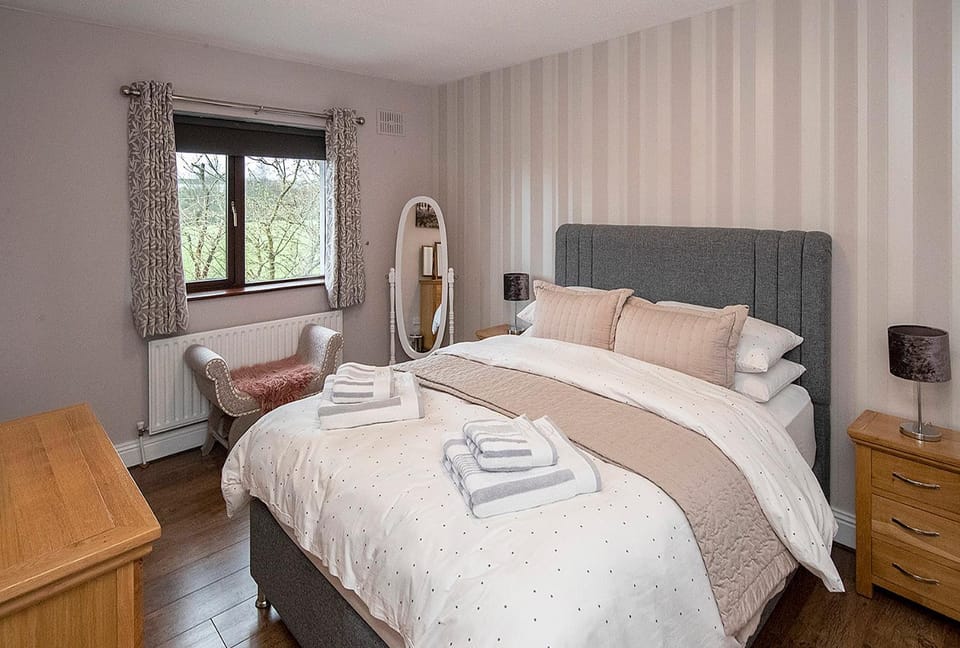 Bed, Bathroom, hair dryier, towels, wardrobe