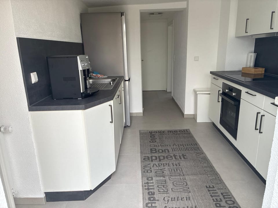 Kitchen or kitchenette, dishwasher, oven, stove