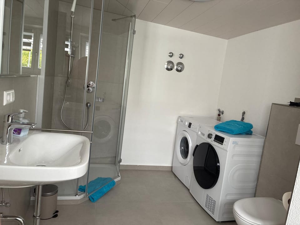 Shower, Toilet, Bathroom, towels, washing machine, dryer