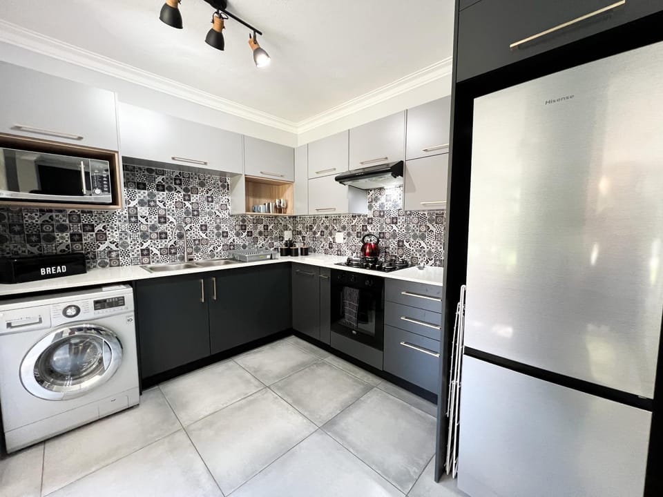 Kitchen or kitchenette, oven, stove, washing machine