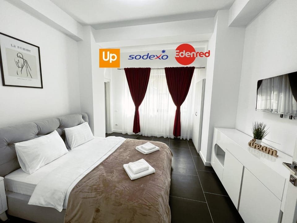 Bed, Property logo or sign, TV and multimedia, Photo of the whole room, Logo/Certificate/Sign, Bedroom, Text overlay, Certificate/Award, towels
