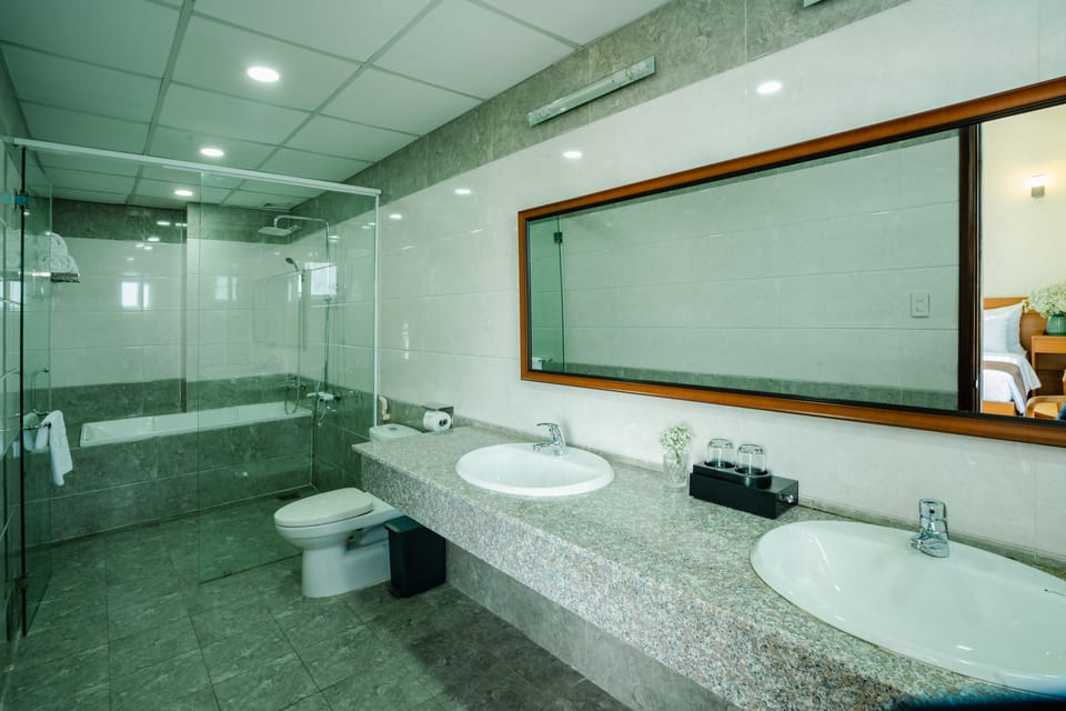 Designer toiletries, hair dryer, slippers, towels