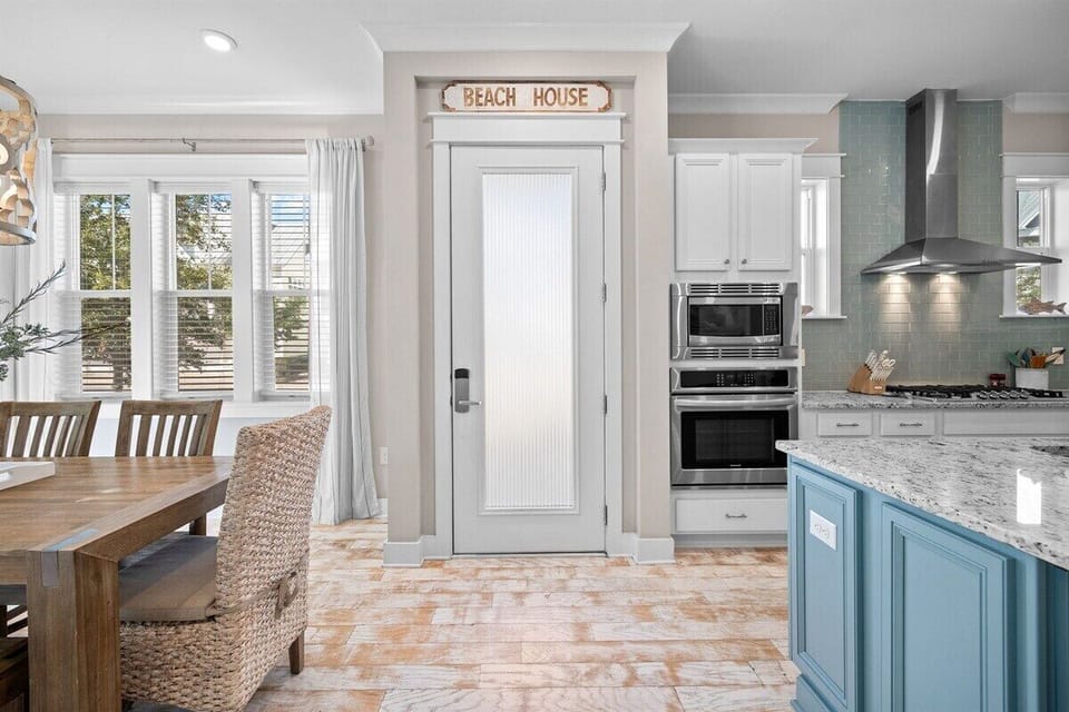 A welcoming entrance leading to a beautifully designed kitchen with ocean-inspired accents.
