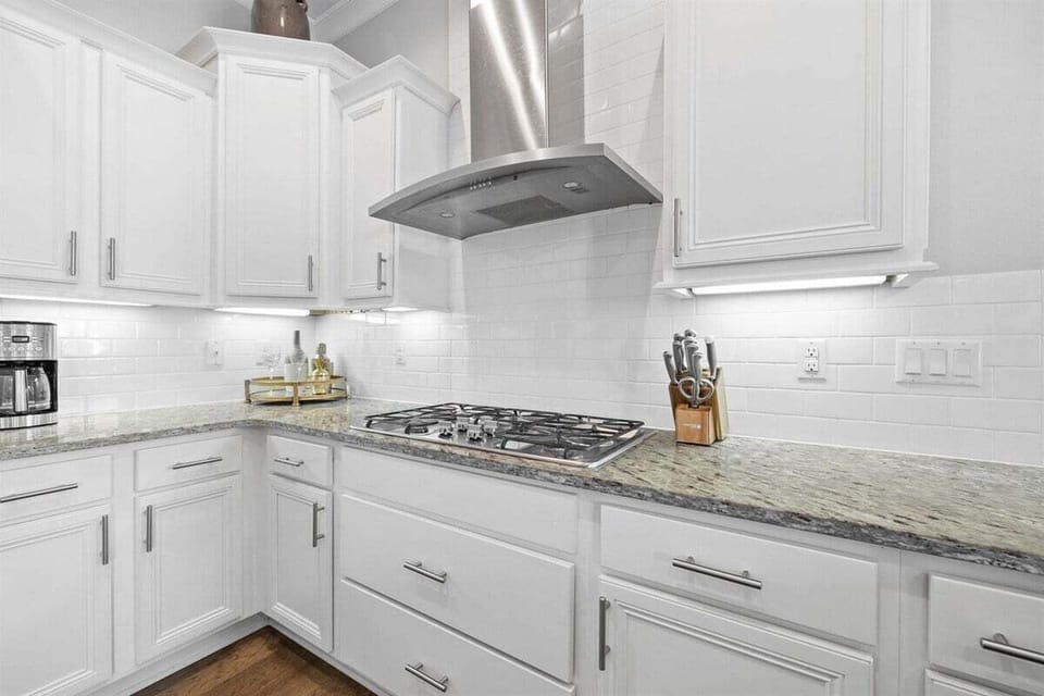 Stainless steel gas range stove and vent.