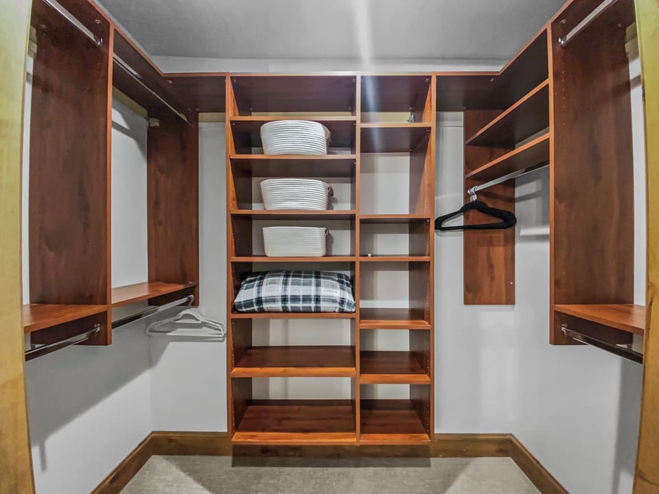 Your personal walk-in closet offers generous hanging space, shelving, and basket storage—a well-organized retreat for all your vacation essentials.