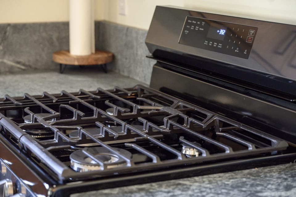 - Modern gas stove with polished design for a seamless cooking setup   - Four burners provide convenience for preparing meals with ease daily   - Stylish black finish complements granite countertops and wood cabinets