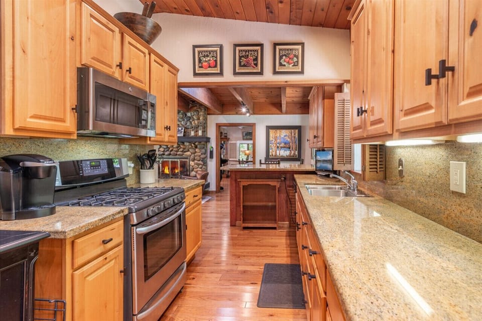Fully stocked kitchen with granite countertops and stainless steel appliances