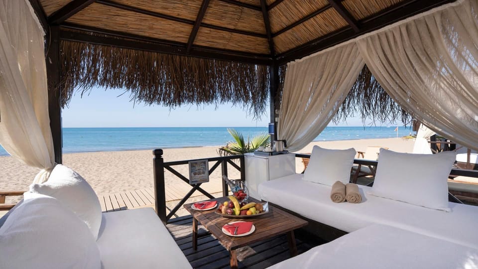 Private beach, black sand, sun loungers, beach umbrellas