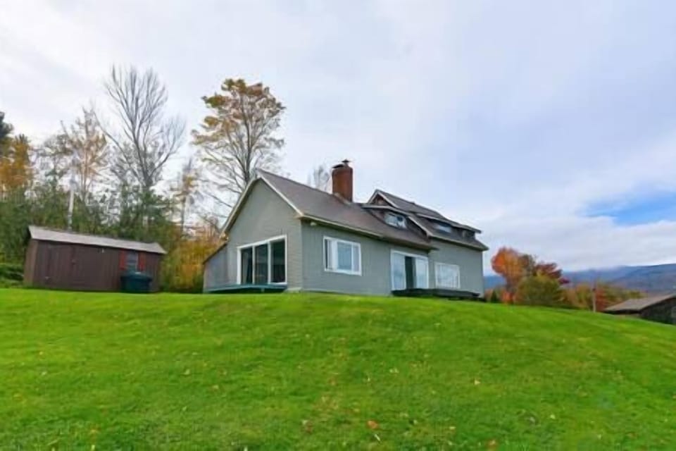 House is at the top of a hill, overlooking the Green Mountains