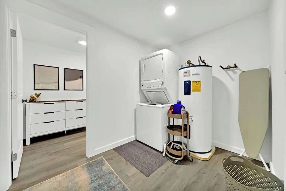 The stackable washer/dryer just off from the 2nd living room leads into the half bathroom that services the middle floor.