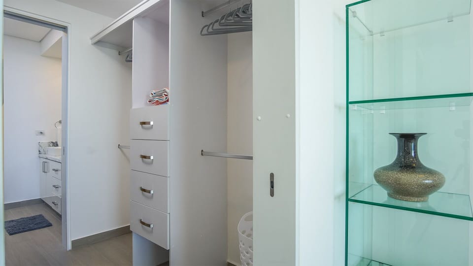 Step into the expansive closet with drawers and lots of places for clothing and more. Walk through to the bathroom.