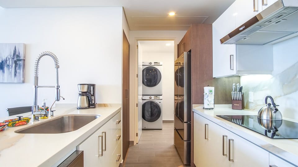 Access the washer and dryer in the utility room past the kitchen.