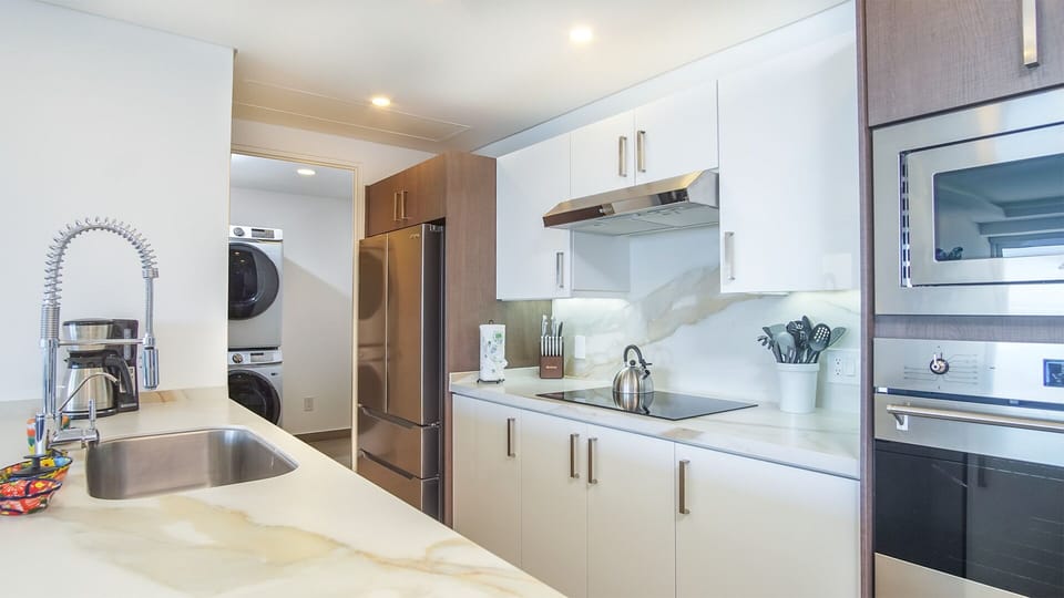 Zoom in on the kitchen full of appliances, cookware, and more.