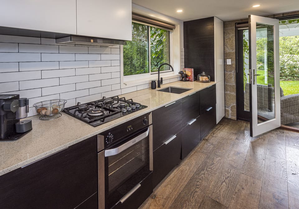 Deluxe Studio Suite | Private kitchen | Espresso maker, coffee/tea maker, full-size fridge, microwave