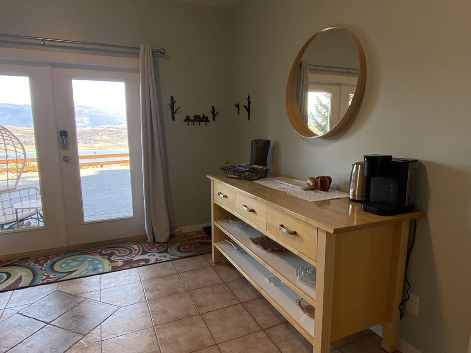 Just inside the main door is this cupboard that holds the coffee maker and info