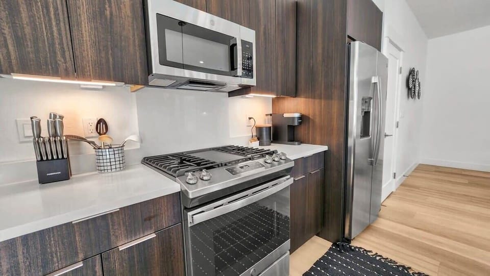 The kitchen is fully equipped with everything you need to prepare a delicious meal including stainless steel appliances and a spacious kitchen island with 3 bar stools.