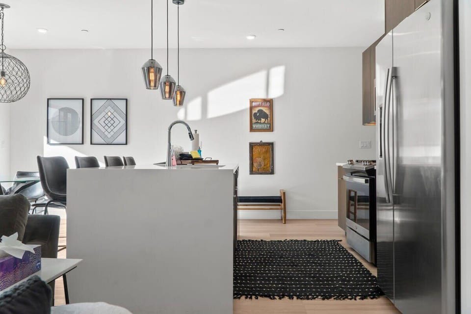 The kitchen is fully equipped with everything you need to prepare a delicious meal including stainless steel appliances and a spacious kitchen island with 3 bar stools.