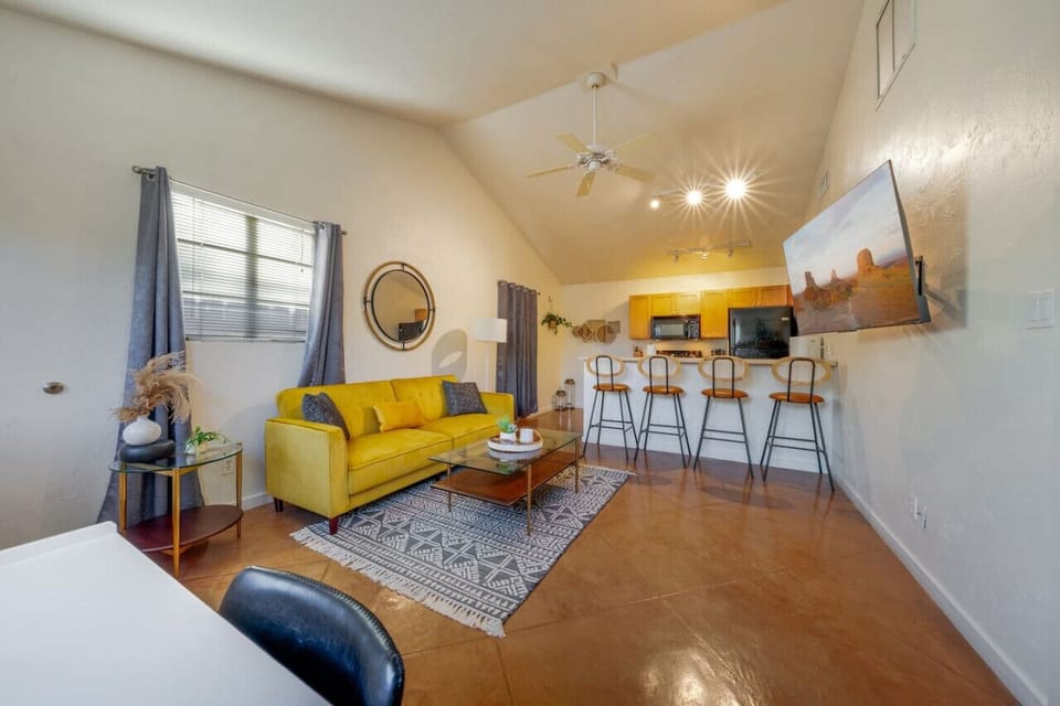 Cozy living room with smart TV, study/work desk, and futon