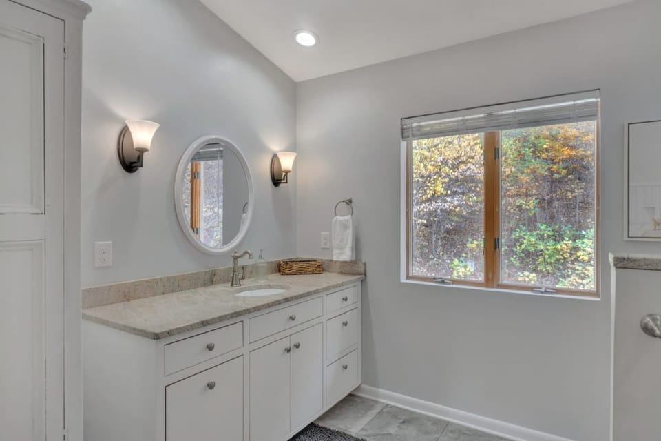 Upstairs bathroom is shared between Primary bedroom and Kids room and has a full-size tub / shower