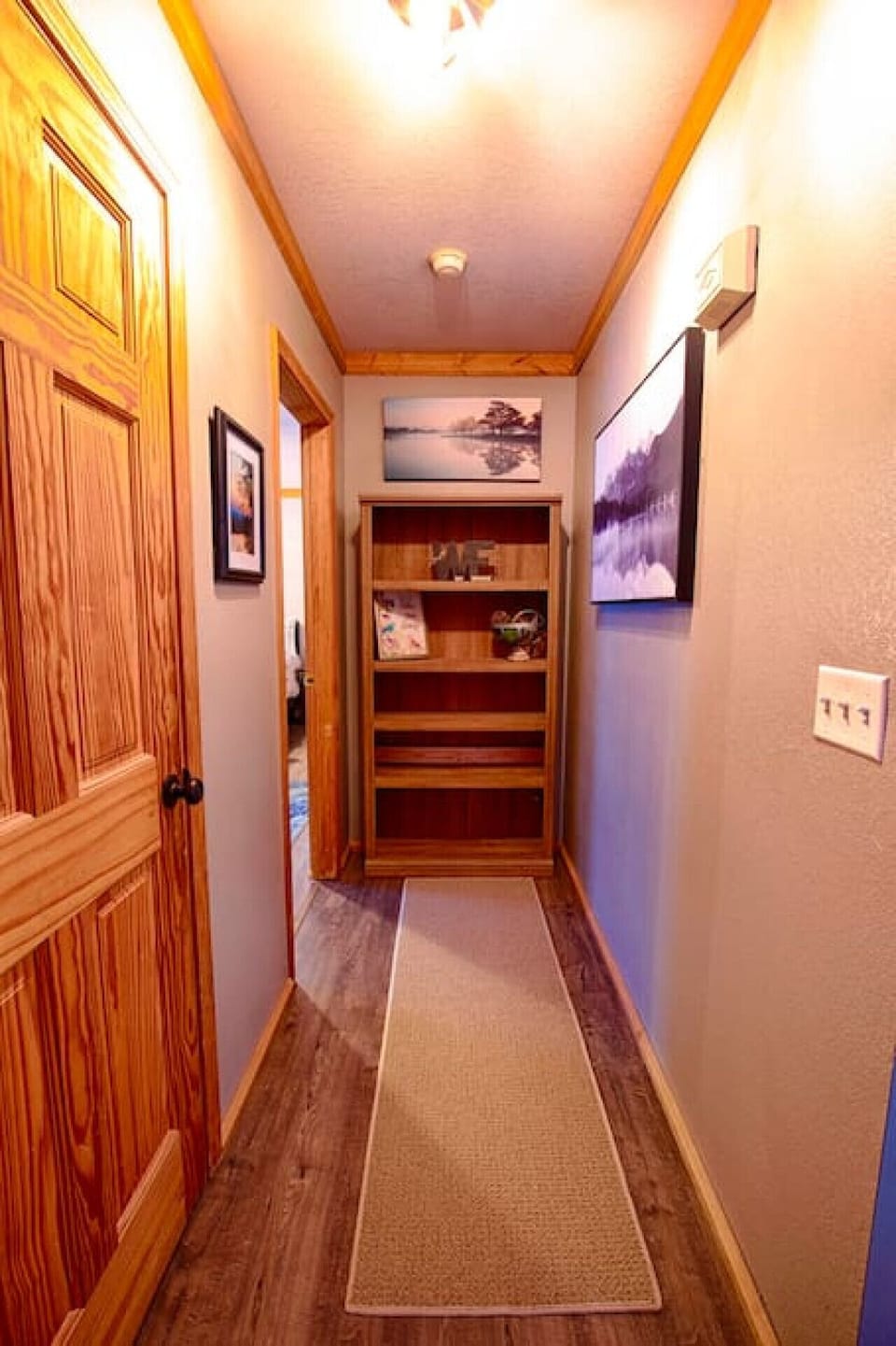 Hallway leading to the master bedroom (half bath door on the left)