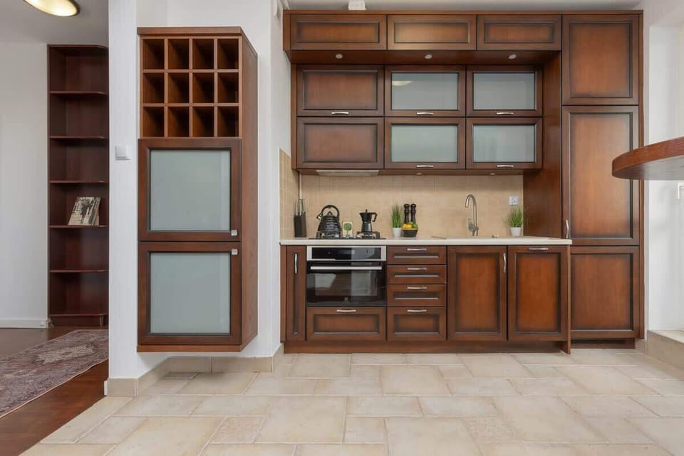 Another perspective of the kitchen, showcasing storage cabinets and a bar-style dining area.
