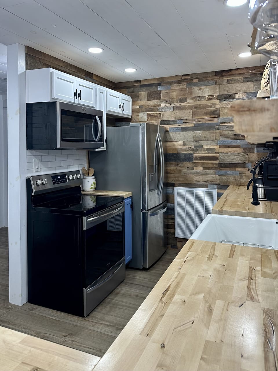 Farm house sink in kitchen with nice appliances.