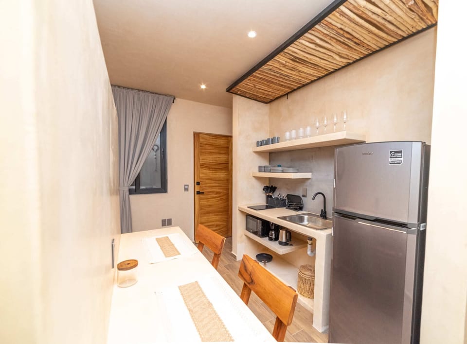 a kitchen with table and refrigerator in Tulum vacation rentals