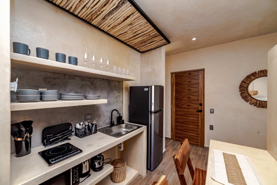 Bedroom with ceiling fan in Tulum apartment