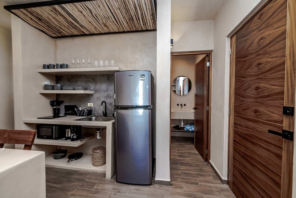 Comfortable room with bed and fan in Tulum apartment