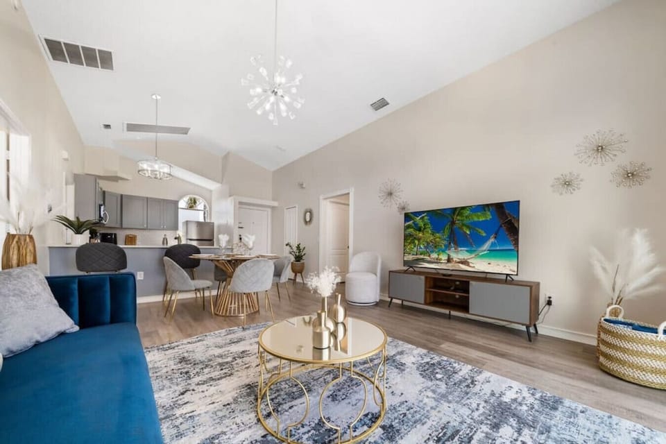 Living Room with 65" Smart TV#Disney #Parks #kingdom #springs #poolhouse #Vacation #Rental #waterpark #Kissimmee #Orlando #universal #citywalk #legoland #shortstay #longstay #bbq #grill #privatepool