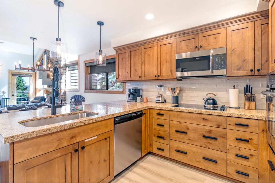 The well-appointed kitchen features stainless steel appliances and generous prep space.