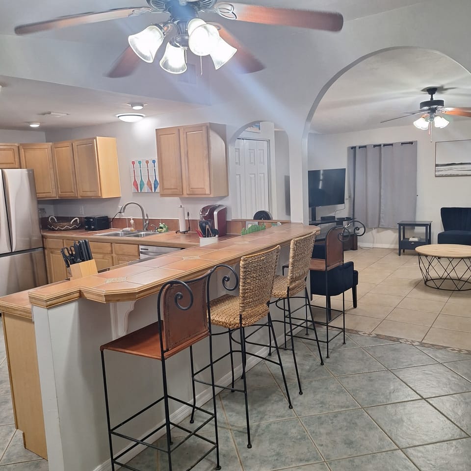 View from dining area into kitchen and living room
