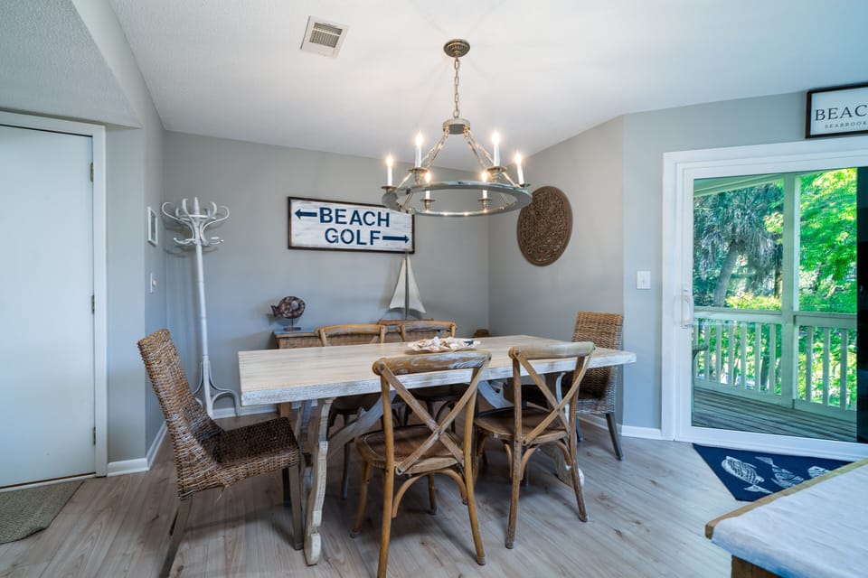 The dining room has a sliding door leading out to the screen porch. The large table is the perfect gathering spot for meals.