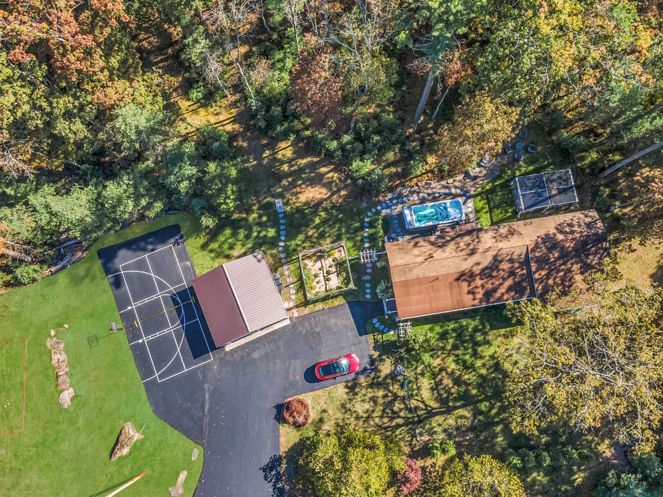 Overhead view of the Garden Cottage pickle ball / basketball courts, Volleyball, SwimSpa, and Flower Garden