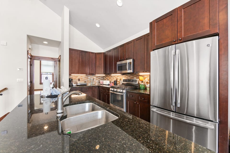 Your fully equipped kitchen features granite countertops, stainless steel appliances, and rich cherry cabinets—perfect for preparing memorable meals.