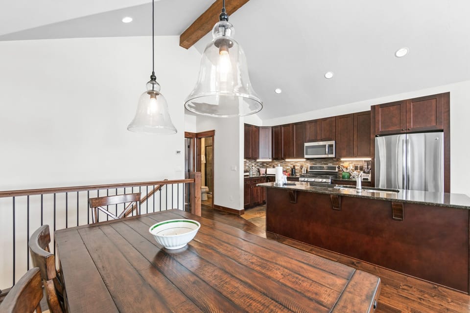 Your fully equipped kitchen features rich wood cabinetry, granite counters, and stainless appliances, perfect for preparing memorable meals.