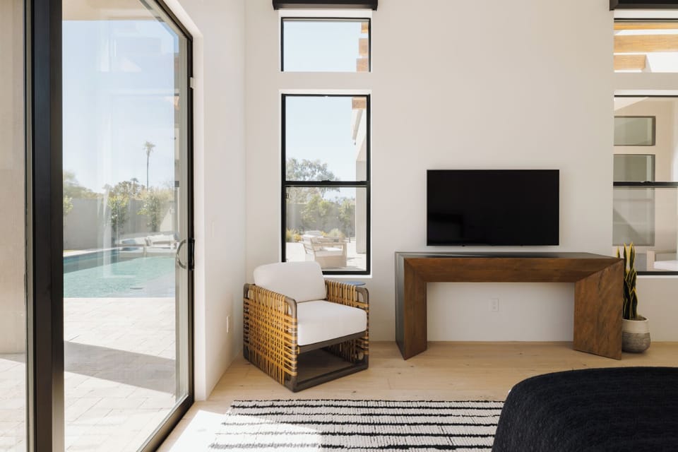 Primary Bedroom with King Bed, TV, Backyard Access, and Bathroom