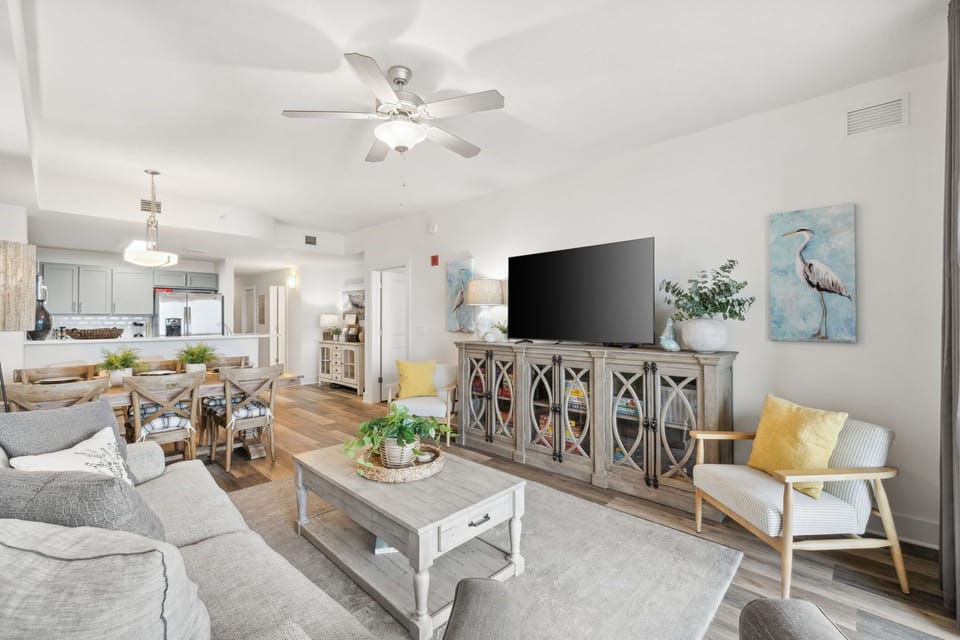 Bright living room with modern furnishings and a large flat-screen tv