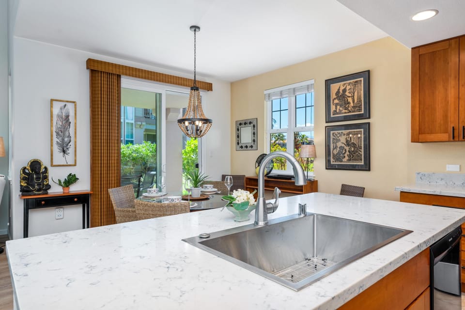 Full kitchen with breakfast bar, granite counters, and modern appliances