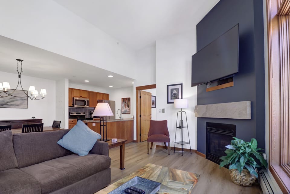 Sink into this stylish living space where your mountain getaway begins. The cozy fireplace invites evening relaxation while the open kitchen beckons you to create memorable meals together.