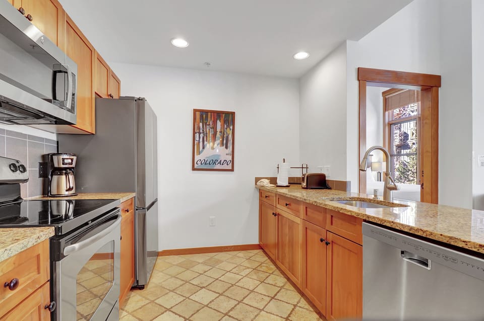 Your fully equipped kitchen awaits with everything you need to create memorable meals during your stay. Warm wood cabinets, granite countertops, and stainless steel appliances make cooking a pleasure.