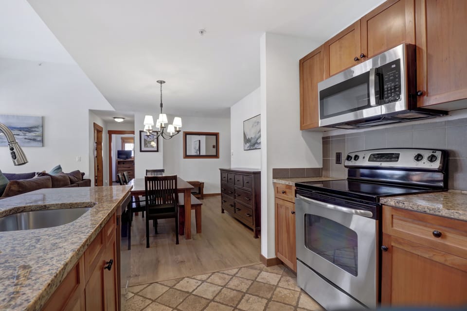Your spacious kitchen awaits with granite countertops, stainless steel appliances, and an open layout that flows seamlessly into your dining and living areas—perfect for cooking memorable meals during your stay.