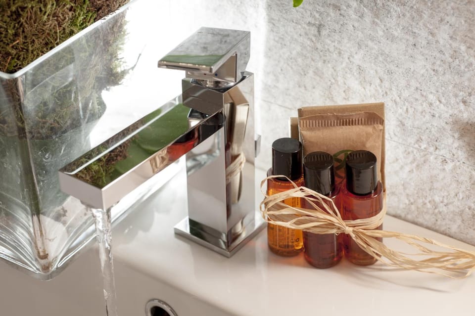 Designer toiletries, hair dryer, slippers, bidet