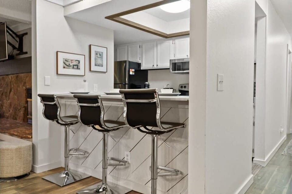 The fully equipped kitchen has everything you need to prepare a delicious meal including spacious white countertops, a large pantry, and a kitchen bar with 3 bar stools.