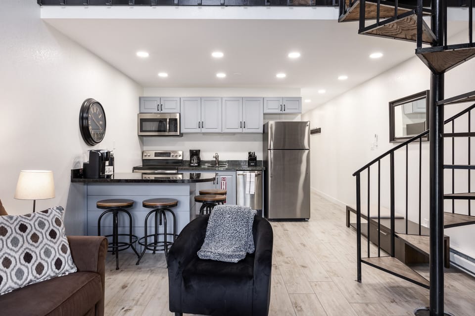 - Modern kitchen with stainless steel appliances included  
- Spacious island bar with seating for cooking and dining  
- Open concept design flows into the living room easily