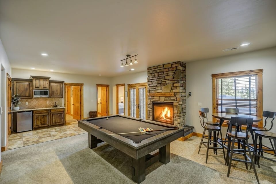 Teens, grown‑ups, and night owls all drift down here eventually--pool table, wet bar, theater room, and hot tub access