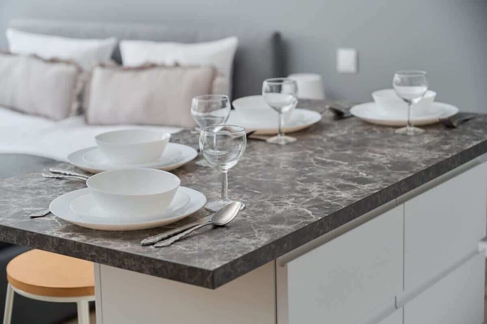 A modern breakfast bar with stools, connecting the kitchen and living room for an open feel.
