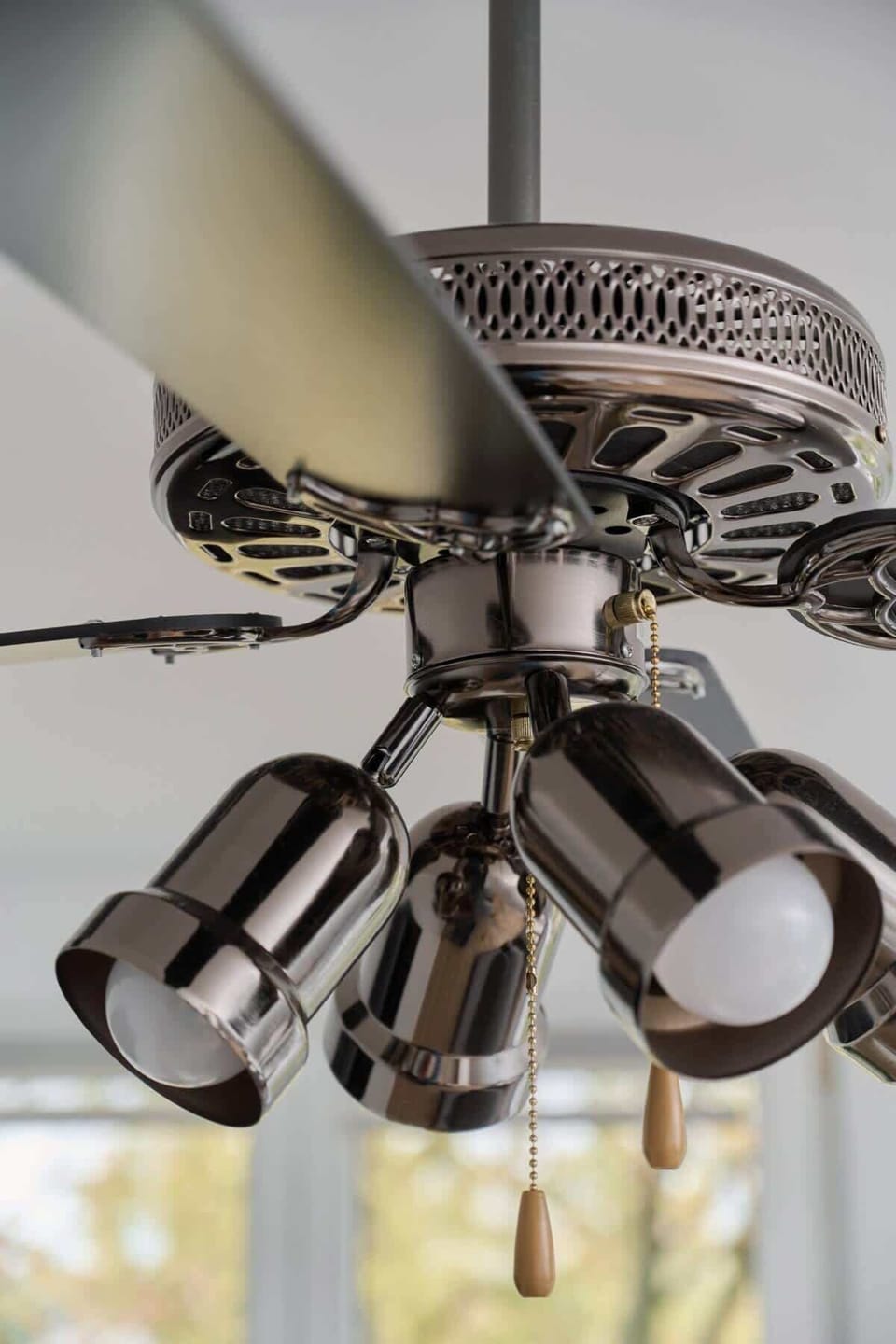 A detailed shot of the ceiling fan with built-in lighting, adding functionality and style.
