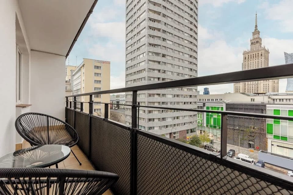 A different angle of the balcony, capturing the view of the Palace of Culture and Science and busy streets.
